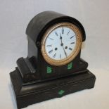 A Victorian mantel clock with circular enamelled dial in black slate and malachite domed case