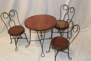 An unusual oak and iron work circular child's size table (17½" high)together with four matching