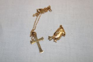 A 9ct gold crucifix with chain and a 9ct gold bird charm (3.