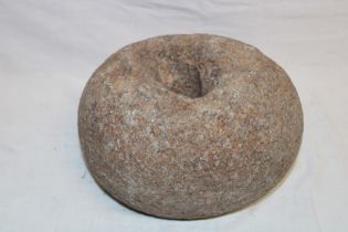 An early Cornish shaped oval granite grindstone, 8" long,