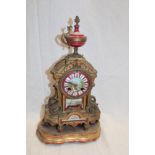 A 19th century Continental gilt spelter mantel clock with porcelain decorated dial and panels on