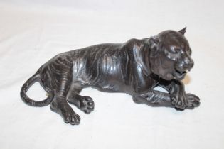 A Japanese bronzed metal figure of a recumbent tiger, 10" long,