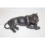 A Japanese bronzed metal figure of a recumbent tiger, 10" long,