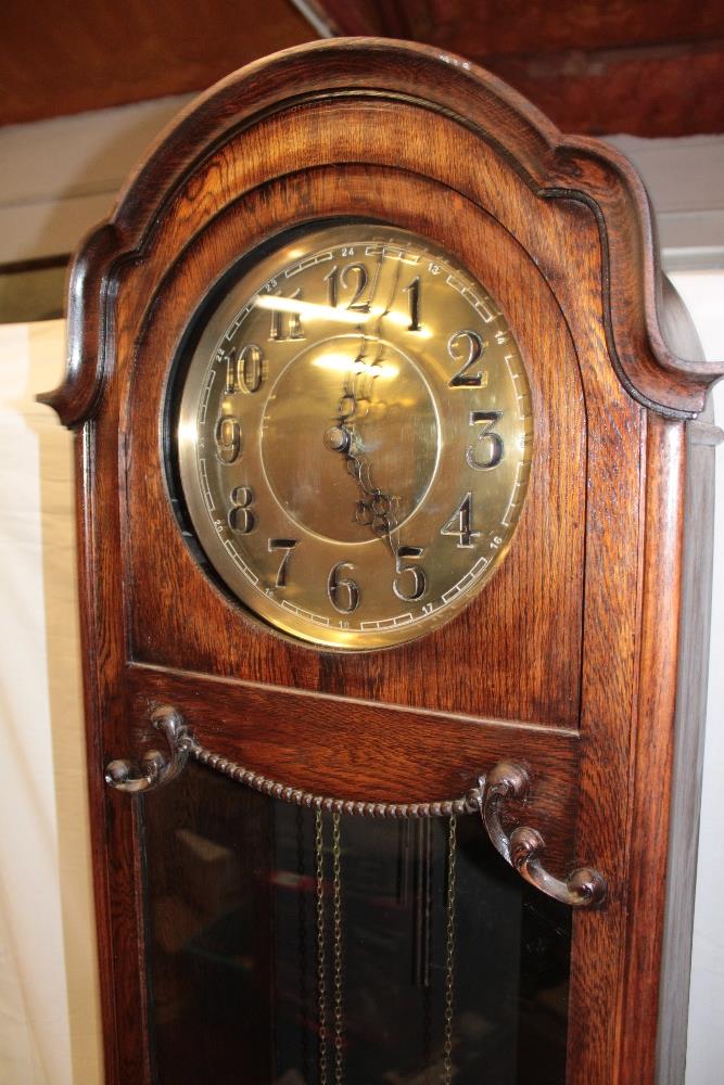 A 1920's/30's grandfather clock with brass circular dial in oak glazed arched traditional case - Image 3 of 3