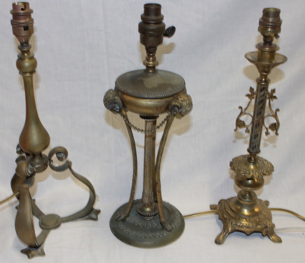 A good quality brass ornamental table lamp with ram's head supports and fluted column and two other