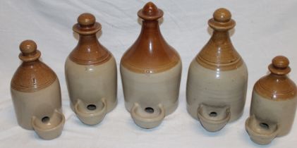 Five old stoneware poultry drinkers, sizes ½, 1,