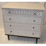 A 1950's/60's formica chest of four long drawers with brass handles,