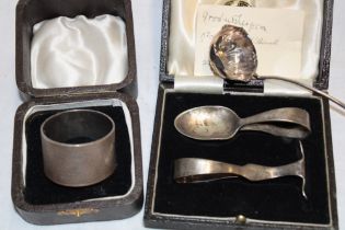 A George V silver circular napkin ring with engraved initials,