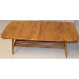 A 1960's/70's Ercol pale elm coffee table with magazine rack on tapered legs,