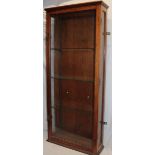 An oak wall mounted glazed collector's cabinet with shelves enclosed by a single glazed door,