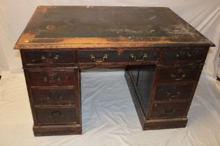 A Victorian oak rectangular pedestal desk with three drawers in the frieze and six pedestal drawers,
