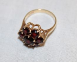 A 9ct gold dress ring set a garnet cluster (3.