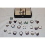 A jewellery box containing 25 various silver dress rings set semi-precious gemstones