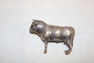 An old silver pin cushion in the form of a standing bull, 2½" long,