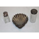 A silver scallop-shaped sweetmeat dish and two various silver topped glass dressing bottles (3)