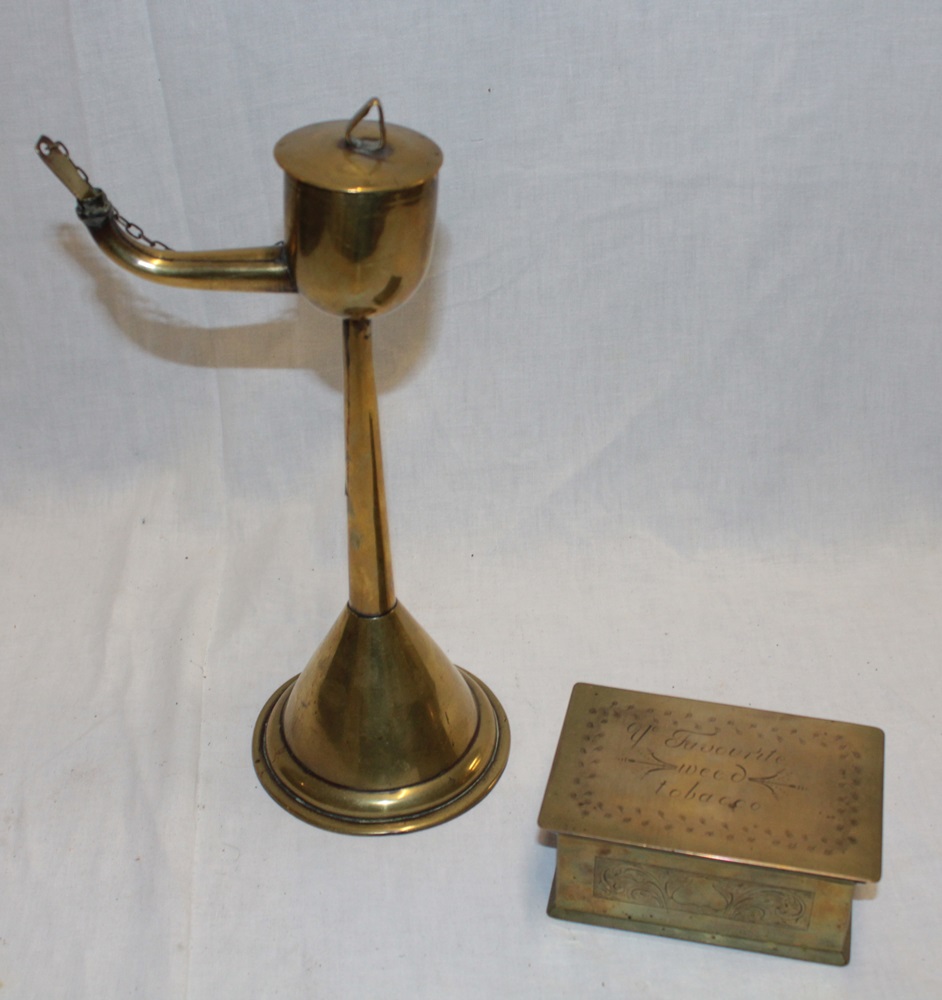 A 19th century brass whale oil lamp with tapered stem and circular base,