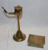 A 19th century brass whale oil lamp with tapered stem and circular base,