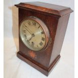 An Edwardian mantel clock with silvered circular dial in inlaid oak rectangular case