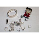 A selection of silver dress rings, silver jewellery including ornate circular pendant,