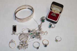 A selection of silver dress rings, silver jewellery including ornate circular pendant,