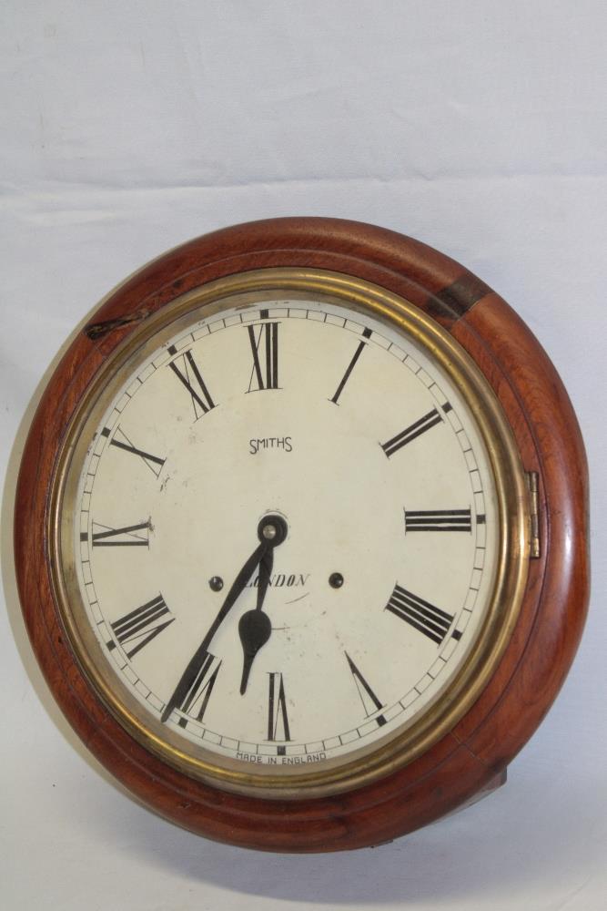 An old wall clock with 11½" circular dial by Smith's of London in polished walnut and brass mounted