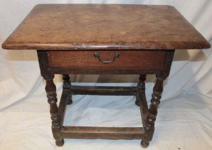 An 18th century oak rectangular side table with a single drawer in the frieze on bobbin turned legs,