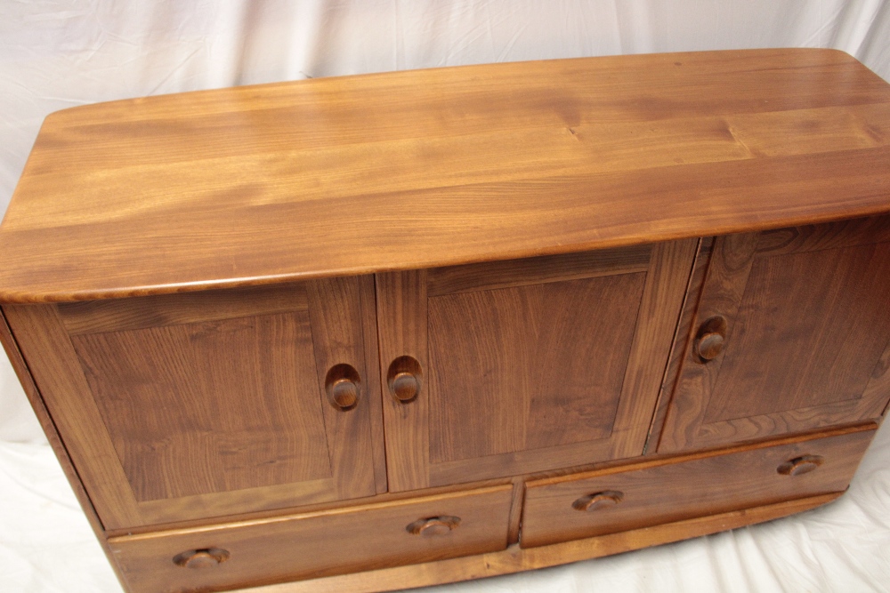 A 1960's/70's Ercol pale elm sideboard with cupboard enclosed by three panelled doors above three - Image 2 of 2