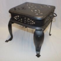 A Victorian painted iron two-handled footman with pierced top on scroll legs,