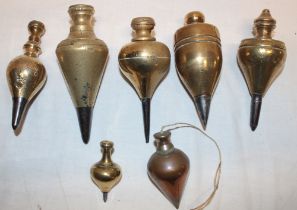 A collection of seven various early brass plumb bobs,