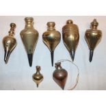 A collection of seven various early brass plumb bobs,