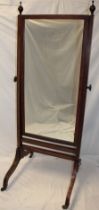 A late Victorian/Edwardian mahogany rectangular cheval mirror on rectangular supports and scroll