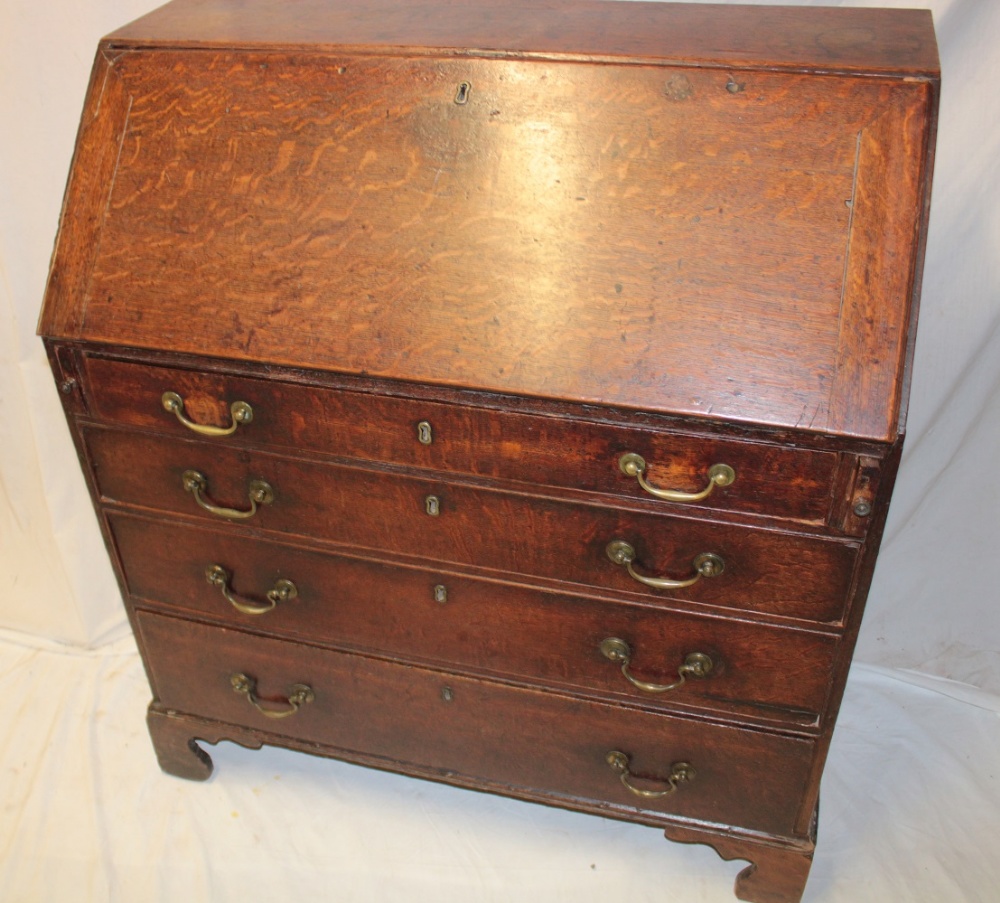 A 19th century oak bureau with numerous pigeon holes and drawers enclosed by a fall front above - Image 2 of 2