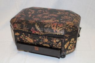 A Victorian lacquered paper mache rectangular sewing box with floral decorated hinged lid and base