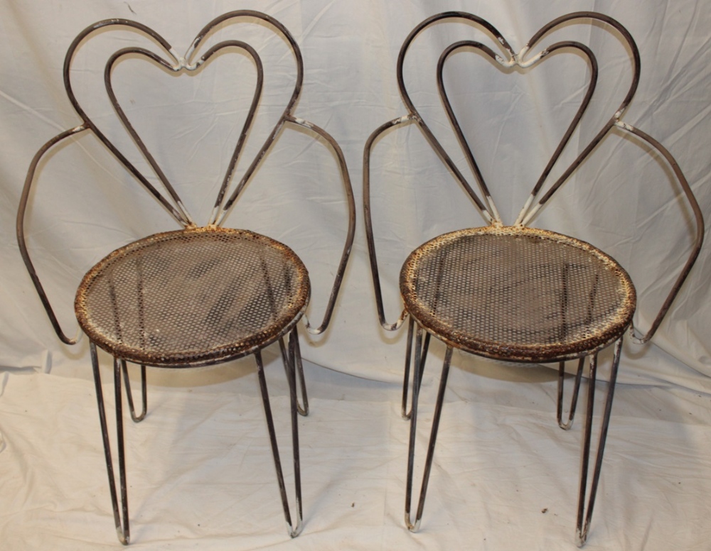 A pair of unusual 1960's iron occasional chairs by Mathieu Mategot with heart-shaped backs and