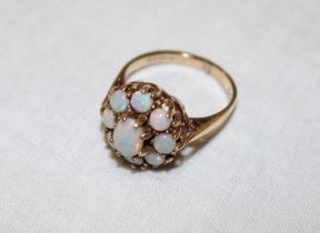 A 9ct gold dress ring set an opal cluster (3.