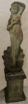 A weathered composition garden figure of a scantily clad female on square-shaped column 64" high