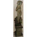A weathered composition garden figure of a scantily clad female on square-shaped column 64" high