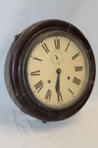 An old wall clock with painted circular dial in polished mahogany circular case