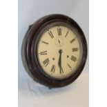 An old wall clock with painted circular dial in polished mahogany circular case