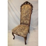 A Victorian carved mahogany hall chair upholstered in floral tapestry on scroll legs