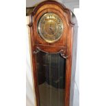 A 1920's/30's grandfather clock with brass circular dial in oak glazed arched traditional case
