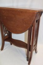 An Edwardian inlaid beech oval drop-leaf tea table on pierced supports