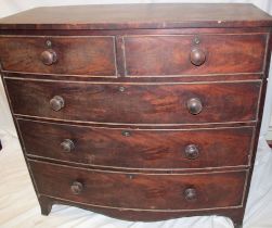 A 19th century mahogany bow-front chest of two short and three long drawers with turned handles on
