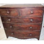 A 19th century mahogany bow-front chest of two short and three long drawers with turned handles on