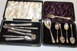 A silver-plated cased double nutcracker set with picks and a small selection of various silver