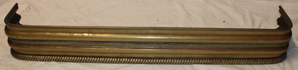 An old brass rectangular fire fender with rope twist decoration 51" long overall