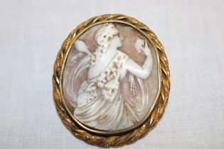 A Victorian pinchbeck oval brooch mounted with a cameo panel depicting a classical female