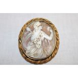 A Victorian pinchbeck oval brooch mounted with a cameo panel depicting a classical female