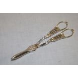 A George V silver grape scissors with scallop decorated handles,