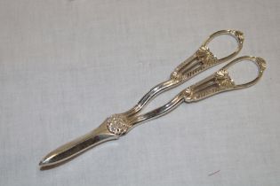 A George V silver grape scissors with scallop decorated handles,